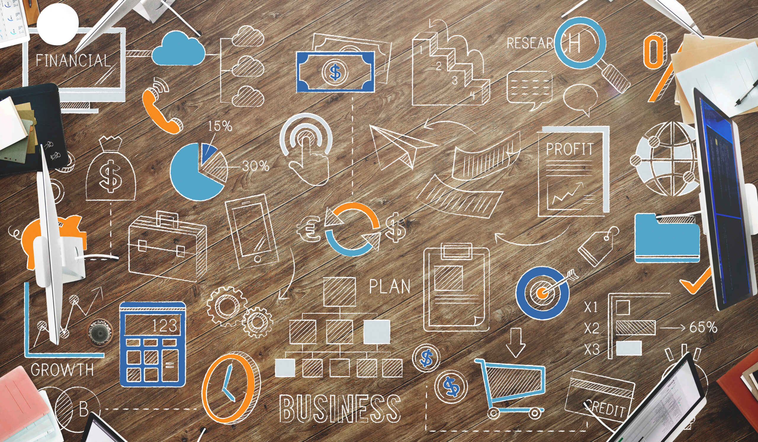 Una superficie in legno con una serie di icone, simboli e scritte relative al mondo del business